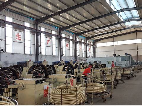 Several workers are operating braided machine.