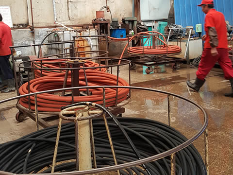 Two workers are demoulding by water pressure.